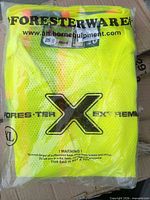 Front of sealed package showing neon vest and branding