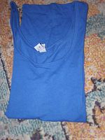Folded blue tank top showing neckline and size tag