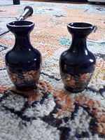 Two matching dark blue miniature vases with gold decoration
