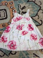 Front view of Penelope girls floral dress laid flat