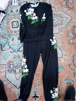 Shirt and pants set laid flat showing floral design and full view