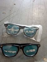 Two pairs of San Jose Sharks novelty sunglasses, one sealed, one loose