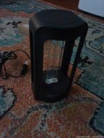 Full view of Sansi UV light fixture on rug, cord visible