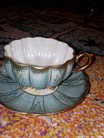 Teacup on saucer showing color, pattern, condition