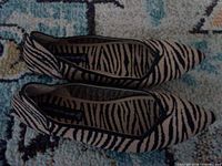 Top view of both zebra print flats showing pattern and condition