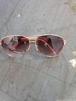 Front view of aviator sunglasses showing frame style and lens tint