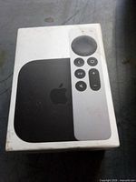 Front of sealed Apple TV 4K retail box showing device and remote
