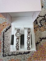 Boxed watch and bracelet set showing design and condition