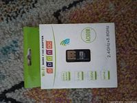 Front of sealed box showing adapter image, AC600 marking, supported bands