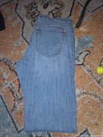 Full view of jeans showing color, style, and pocket detail