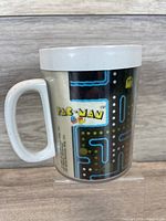 Left side view showing Pac-Man maze graphic and white handle