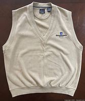 Front view of cream sweater vest with logo