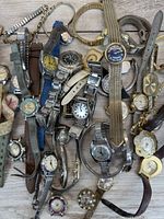 Pile of assorted vintage wristwatches showing range of styles and straps