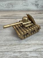 angled view showing entire tank sculpture made of brass shell casings