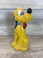 Front view of yellow Pluto ceramic figurine