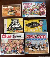 Six boxed board games laid out together