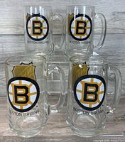 Front view showing Boston Bruins logos on four glass steins