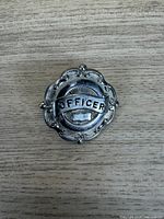 Front view showing OFFICER text and ornate border