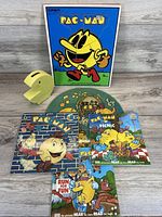 Overall lot layout showing puzzle, bank, three books, record sleeve