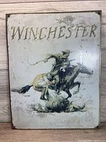 Front view of Winchester metal sign showing full artwork and size proportions