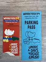 Red Woodstock 94 guide/ticket and blue parking pass side by side