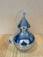 Front view of chrome pendant with cord and canopy