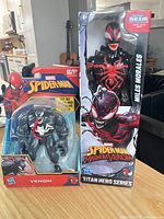 Front view of both sealed action figures on table