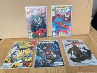 Group shot of all five bagged comics on table