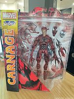 Front view of sealed Carnage figure with accessories in package