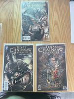 Overview of three bagged Texas Chainsaw Massacre comics on table