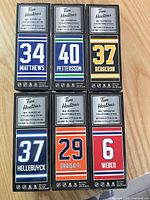 Front view of six Tim Hortons collectable stick boxes showing player numbers