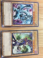 Both oversized promo cards in sleeves, full view