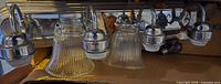 four-light chrome vanity fixture with ribbed glass shades