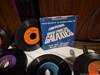 Front view showing picture-sleeved record and several loose 45s