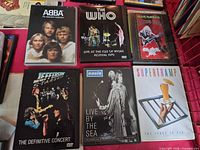 Front covers of all six DVDs arranged on surface