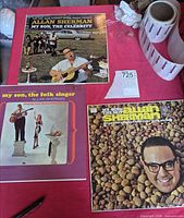 All three album covers laid out on table
