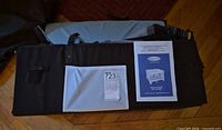 Folded playard with owner’s manual and light blue mattress/pad
