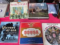 Six LP jackets displayed on tabletop showing titles and cover art