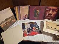 Group shot showing all album covers laid out on cloth