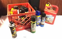 Overall view of crate with multiple aerosol insecticide cans and Sevin jug