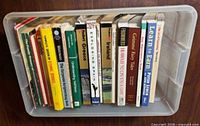Top-down view showing all books arranged in clear tote, spines readable