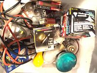Assorted loose bulbs, cord, packaged bulbs inside bin