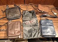 Overview of five crossbody bags and one OYO drawstring sack on table