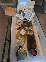 overview of assorted decor items in plastic bin