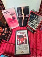 Front covers of five VHS tapes displayed in basket