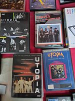 Front covers of four Utopia DVDs arranged on table