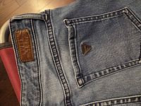 Back pocket view with leather Guess patch and triangle logo