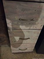 Front view showing three drawers