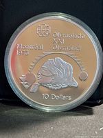 Reverse side of coin showing Olympic design and denomination