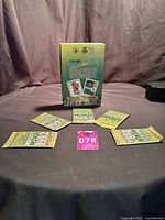 Front view of five sealed packs with display box